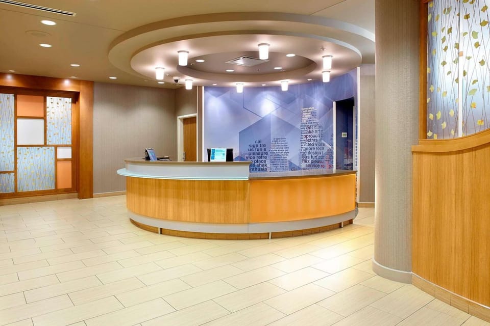 Bright front desk check-in area with curved counter