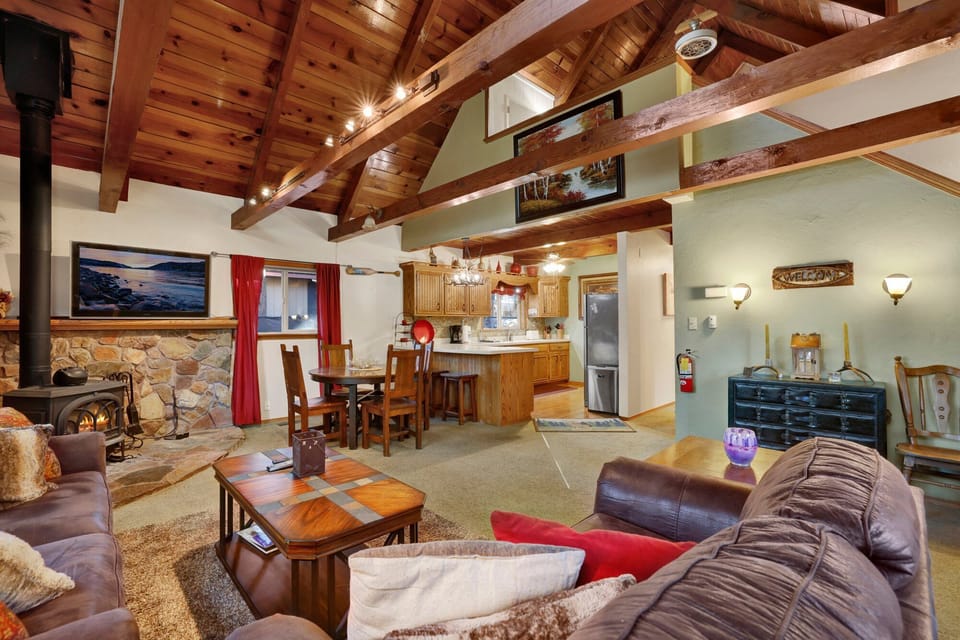 Cozy mountain living room with a fireplace, comfy seating, and smart TV perfect for relaxing evenings,