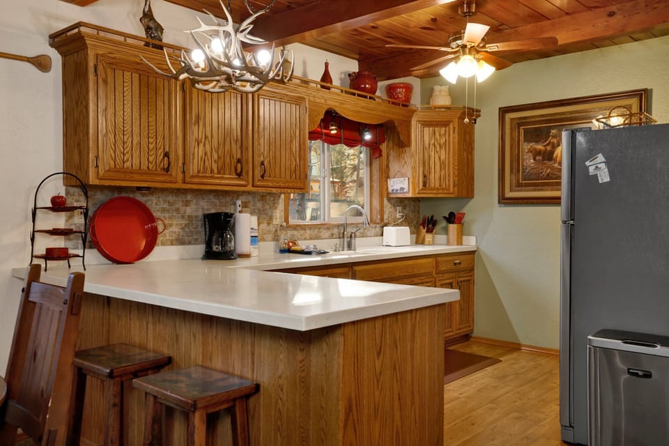 Fully equipped cabin kitchen with ample cabinetry, stove, fridge, microwave, and coffee maker—perfect for cooking meals, morning coffee, and feeling right at home on your stay.