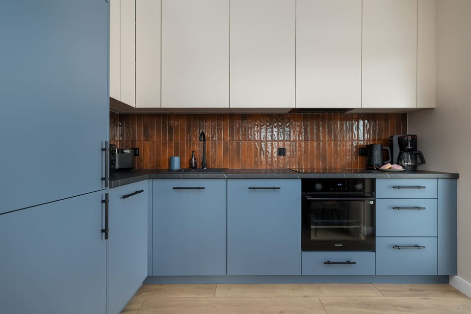 The thoughtfully designed kitchen with elegant cabinetry and a practical layout makes it easy to prepare meals in a clean and comfortable setting.