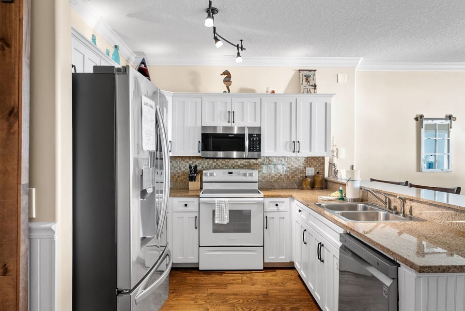 The fully equipped kitchen features granite countertops, mostly stainless-steel appliances, and has everything you need to prepare meals for family & friends.