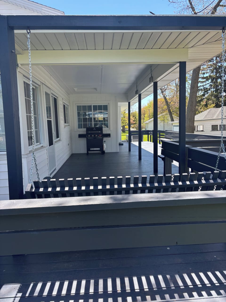 Covered Roadside Porch with swing, benches and grill