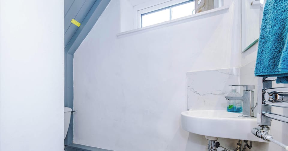 A clean and modern full bathroom featuring a spacious shower, sleek fixtures, and ample storage. Soft lighting and fresh towels create a relaxing, spa-like experience.