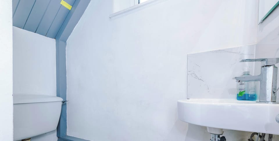 A clean and modern full bathroom featuring a spacious shower, sleek fixtures, and ample storage. Soft lighting and fresh towels create a relaxing, spa-like experience.