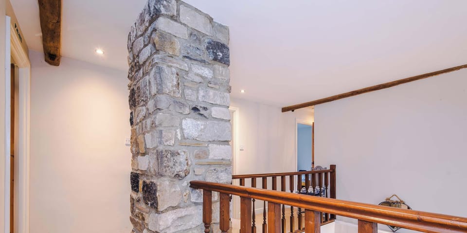 A bright and welcoming living room with comfortable seating, soft lighting, and a warm, inviting atmosphere perfect for relaxing or entertaining guests.