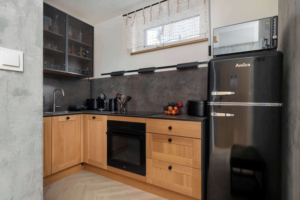 The sleek design of the kitchenette blending seamlessly with the living area.