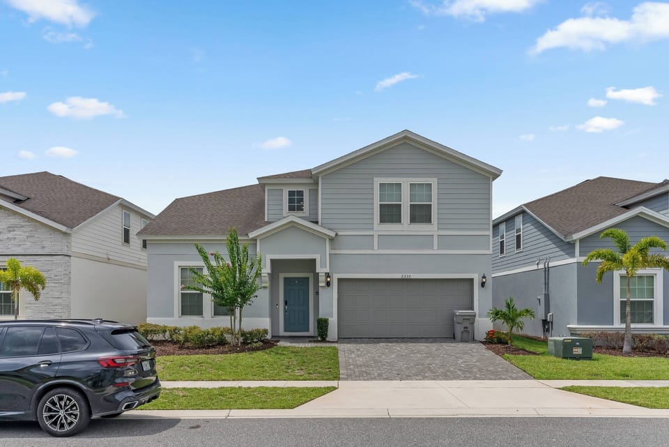 Welcome to this charming home with soft blue siding and lush green landscaping. The inviting porch greets you, while the spacious driveway provides ample room for your vehicle, ensuring convenience from the moment you arrive.