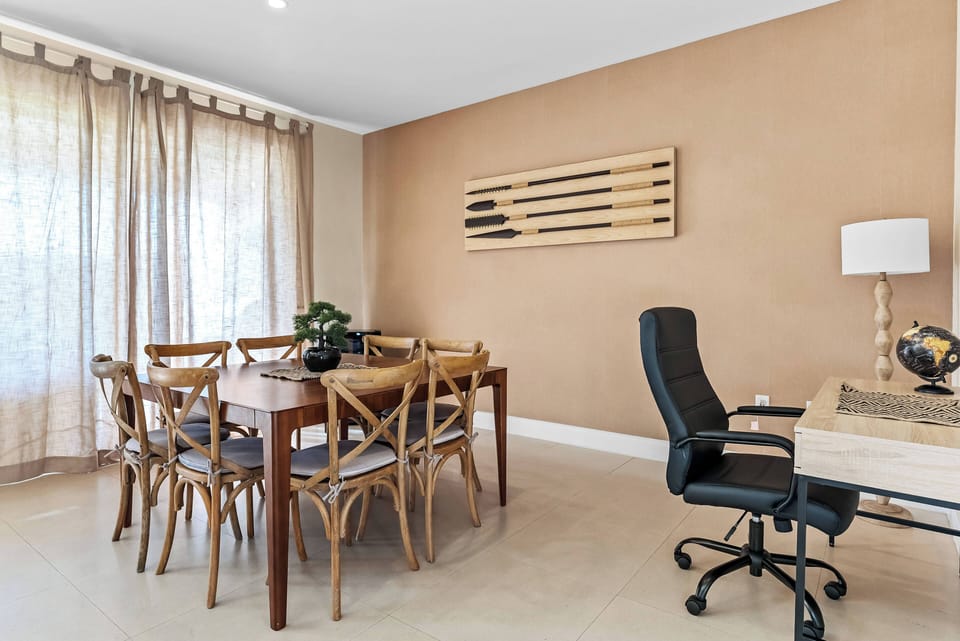 Enjoy family meals and game nights at the rustic wooden dining table, surrounded by cozy warmth and natural light. A stylish desk in the corner is perfect for work or planning your next adventure.