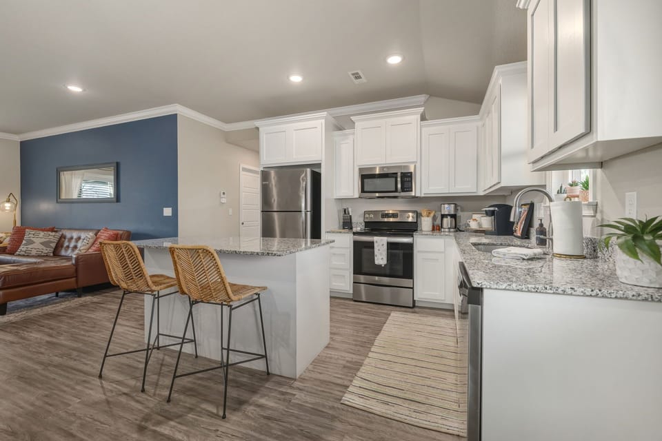  The living room features a Smart TV with all your favorite streaming channels, along with cozy seating, and colorful decor.