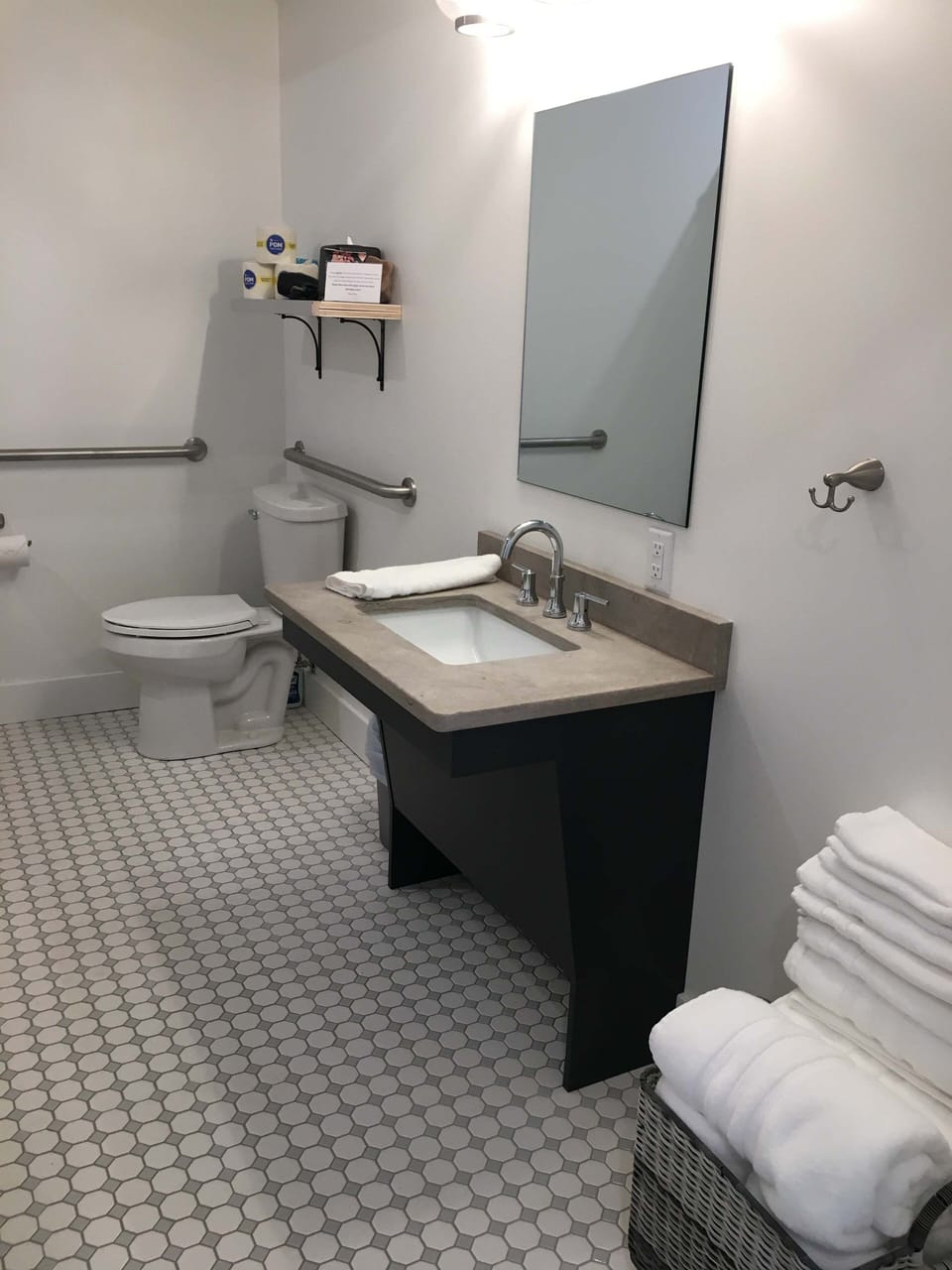 Enjoy a clean and contemporary bathroom featuring a modern vanity, bright lighting, tiled flooring, and a spacious glass-enclosed walk-in shower.