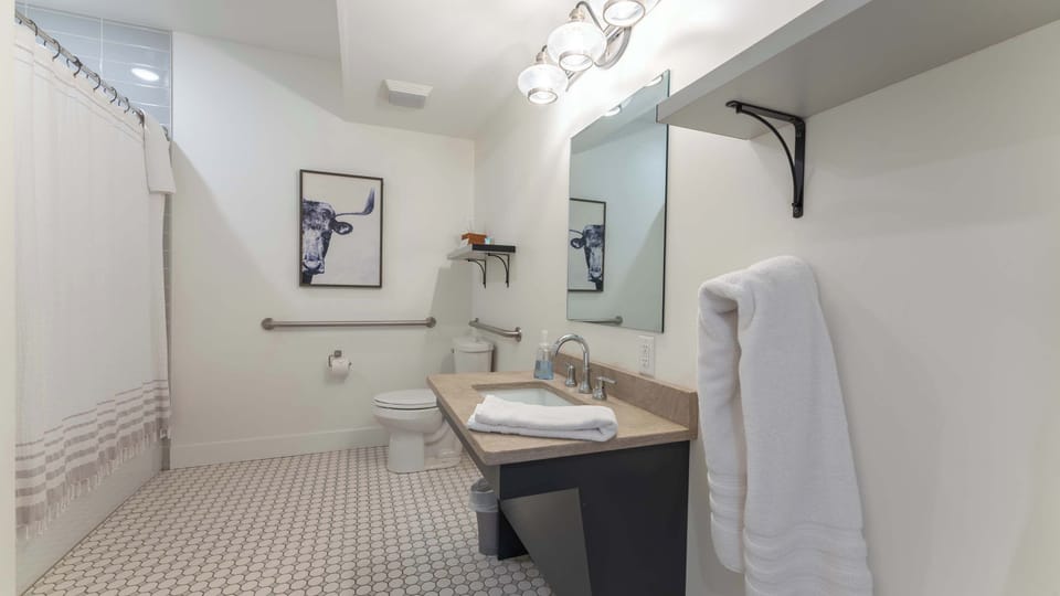 Refresh in this bright, contemporary bathroom featuring a spacious walk-in shower, clean tile finishes, modern fixtures, and a convenient vanity area.