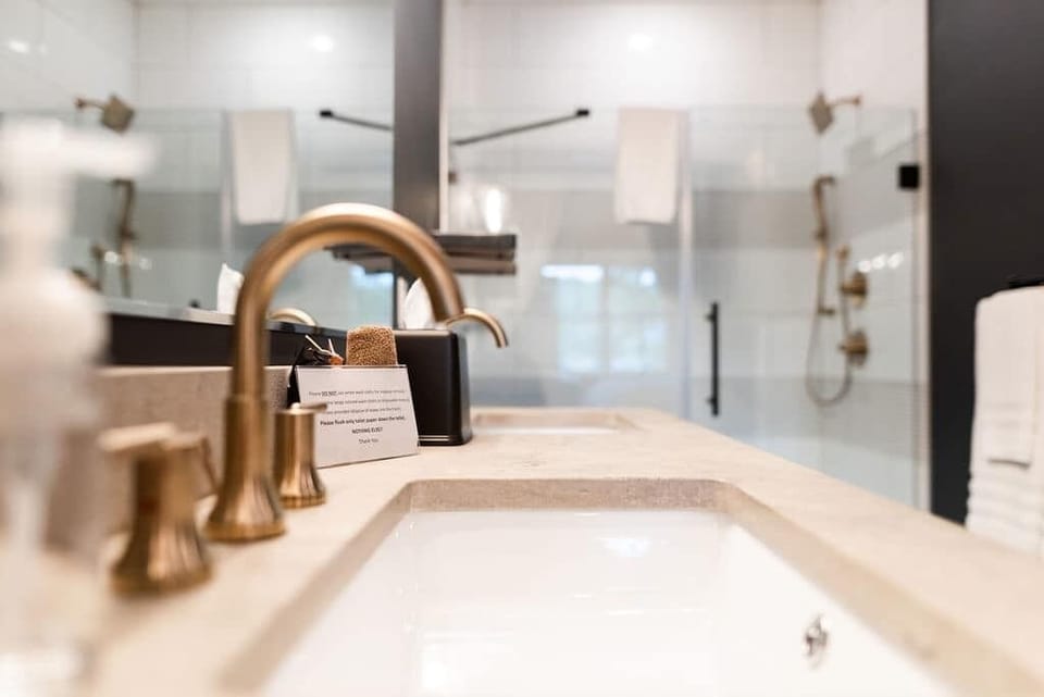 Stylish Bathroom Vanity — Elegant bathroom vanity with modern fixtures, warm finishes, and thoughtful details for a comfortable stay.