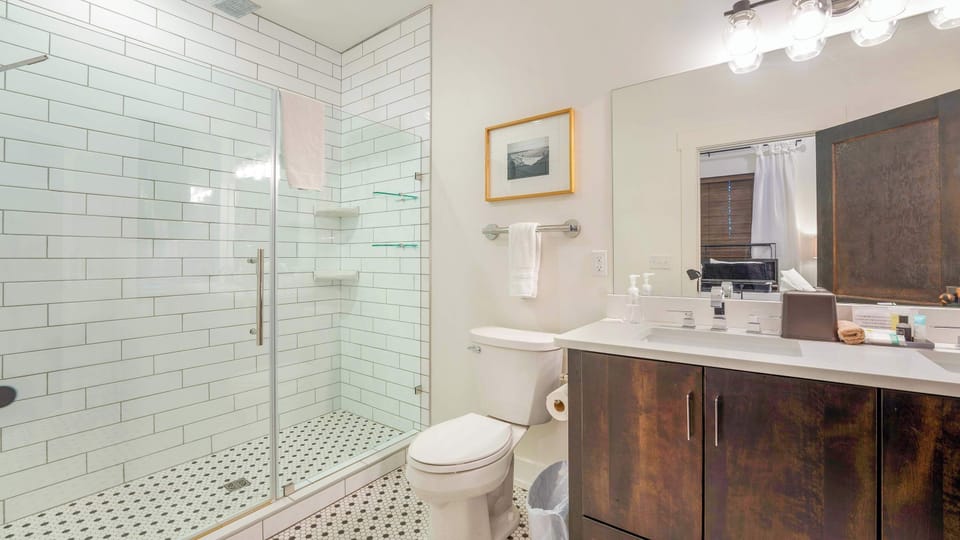 Clean and stylish bathroom with a glass-enclosed shower, vanity, and contemporary finishes.