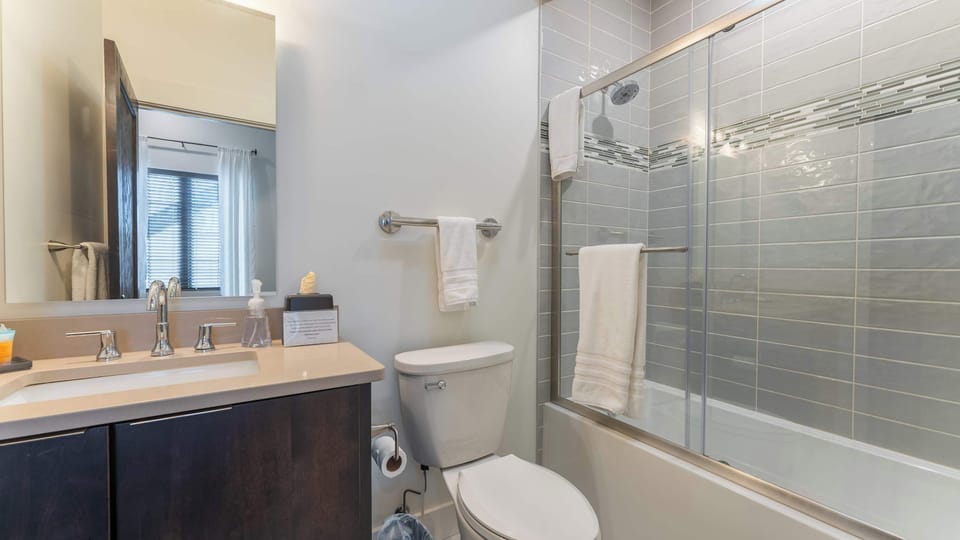 Refresh and unwind in the modern full bathroom featuring a spacious glass-enclosed shower, contemporary vanity, sleek fixtures, and clean finishes.
