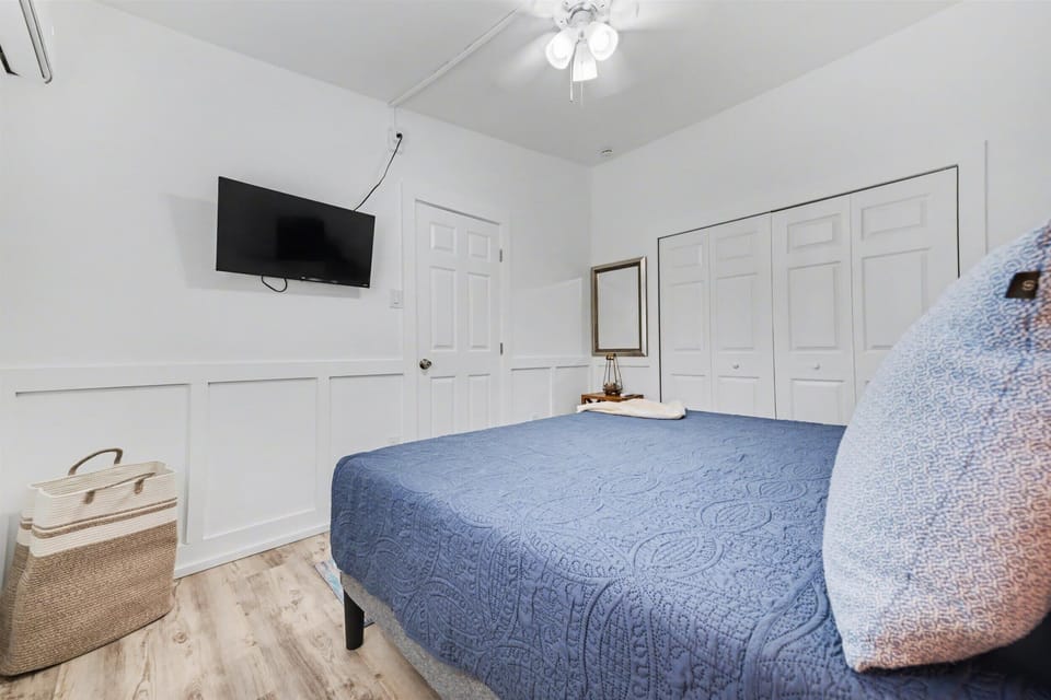 Bedroom with smart TV, queen bed, and peaceful vibes