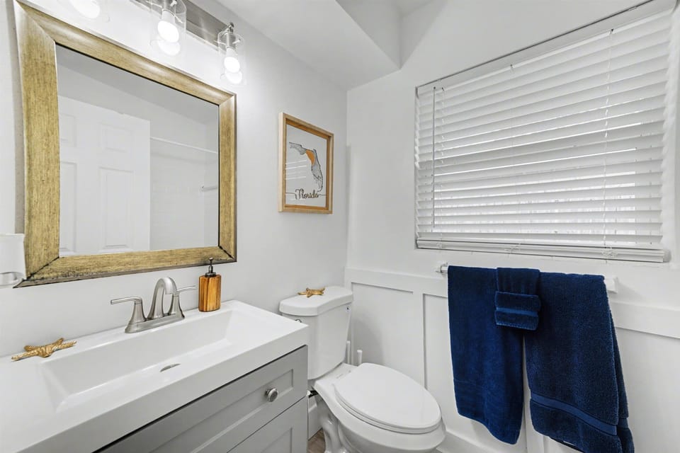 Refresh and recharge in your private bathroom with coastal touches and plush navy towels waiting for you.