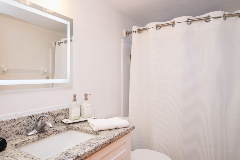 Full Guest Bathroom with Shower/Tub Combo and Granite Vanity. Clean, bright, and convenient for families.