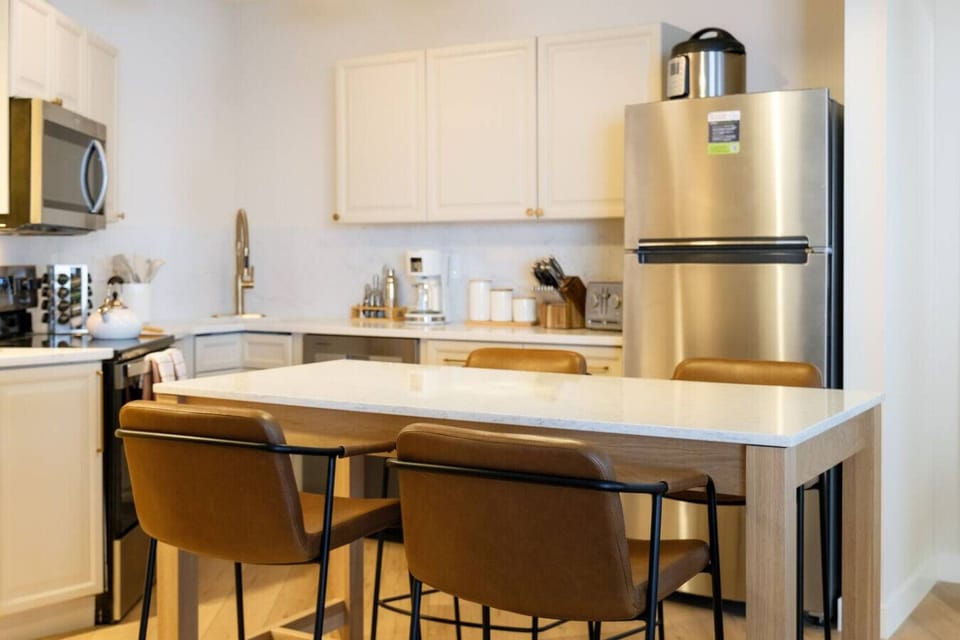 Kitchen includes seating for four, microwave, fridge, oven, dishwasher, coffee maker, toaster, instant, slow cooker, blender, espresso machine, and coffee grinder