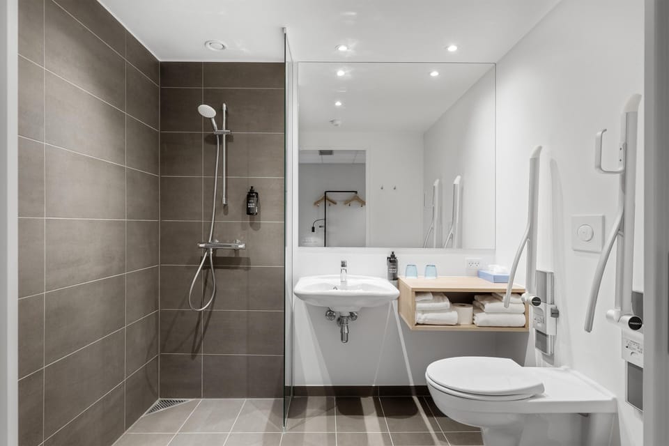 Standard Room - 1 Queen Bed - Disability Access - Non-Smoking | Bathroom | Shower, hair dryer, heated floors, towels