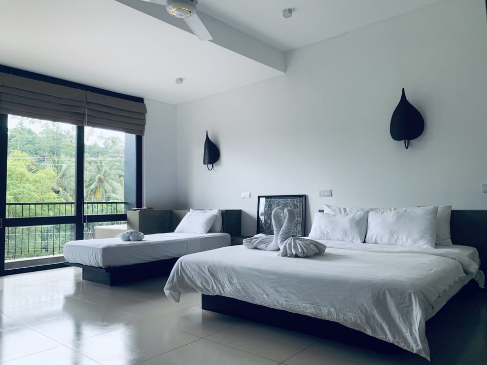 Deluxe Triple Room, 1 Bedroom, Garden View | Minibar, in-room safe, individually decorated, individually furnished