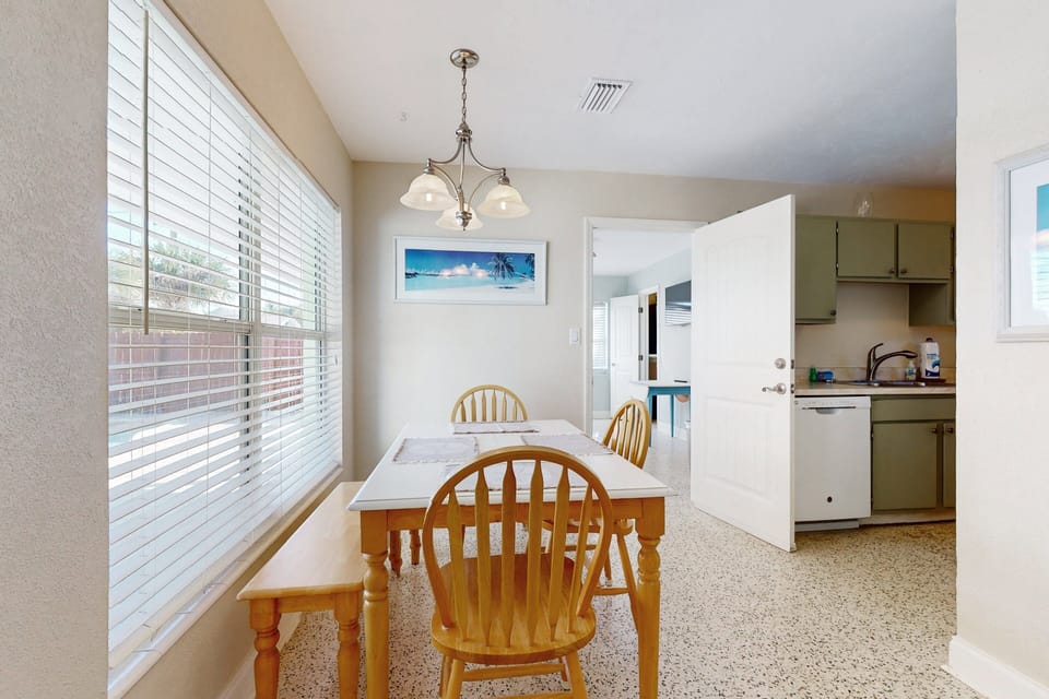 Gather in this bright dining space, perfect for your beach stay. Enjoy meals together after a day by the shore, with coastal décor and easy access to the kitchen for relaxed, seaside-inspired dining.