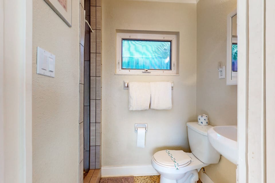 Refresh after a day at the beach in this clean, bright bathroom. Designed for a comfortable beach stay, it offers a walk-in shower and coastal simplicity—perfect for rinsing off sand and relaxing.
