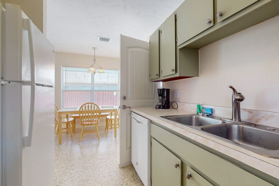 This well-equipped kitchen makes your beach stay easy and convenient, with everything needed to prepare meals. Enjoy a clear view into the dining area, perfect for relaxed mornings and laid-back evenings by the beach.