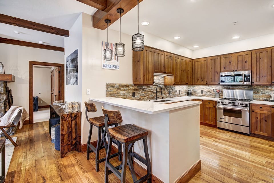 This stylish kitchen combines rustic charm with contemporary design, offering a perfect space to prepare meals while enjoying the stunning mountain surroundings.