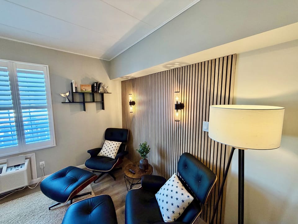 Cozy modern lounge nook with designer seating and warm accent lighting