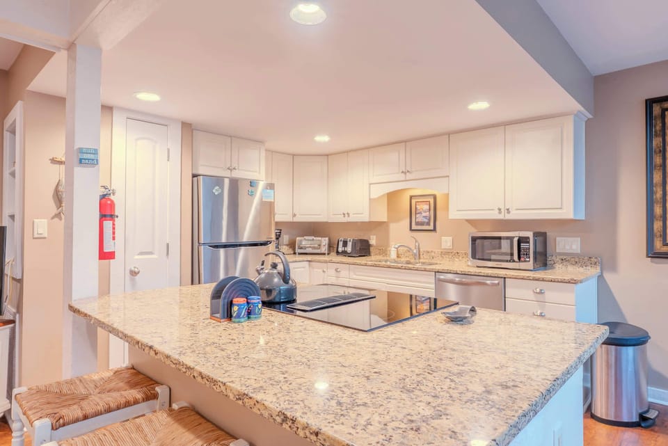 A bright, modern kitchen fully equipped with everything you need for easy vacation meals.