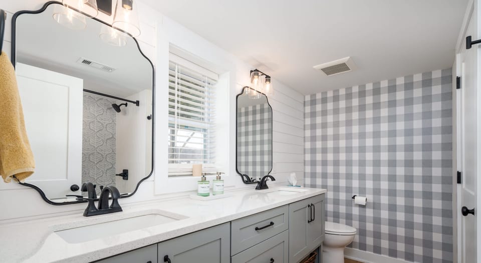 Lower level double sink bath with tub/shower