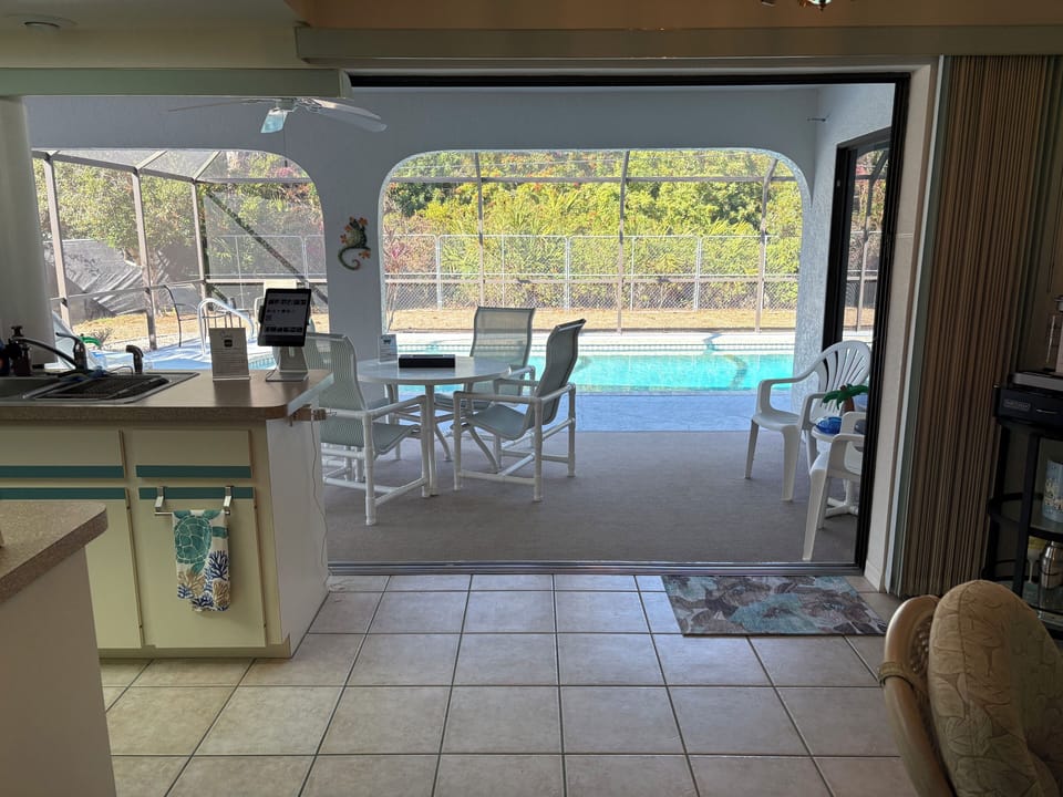 Triple Sliding Glass Doors open to Pool Deck Area