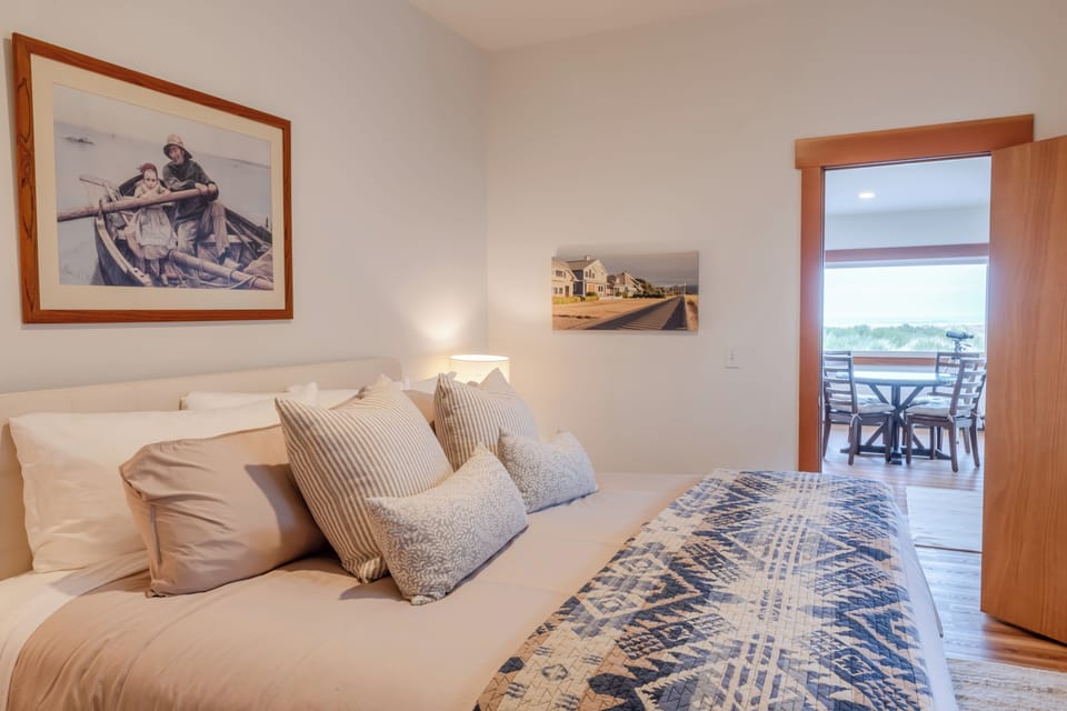 Comfortable and inviting primary suite featuring a king bed and a peaceful coastal atmosphere.
