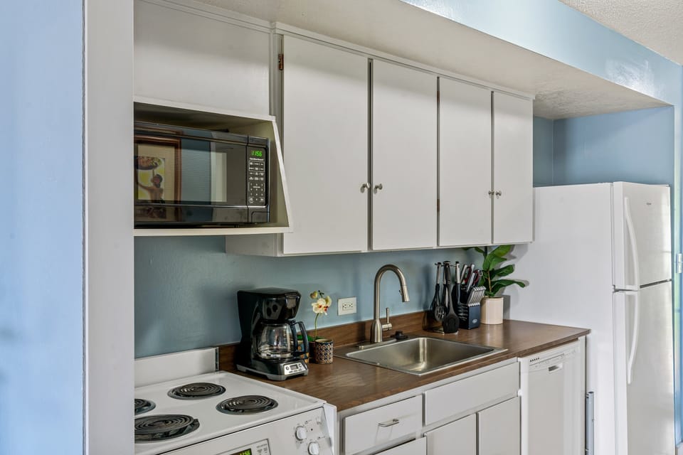 Prepare meals in comfort with modern appliances and a cozy, coastal vibe