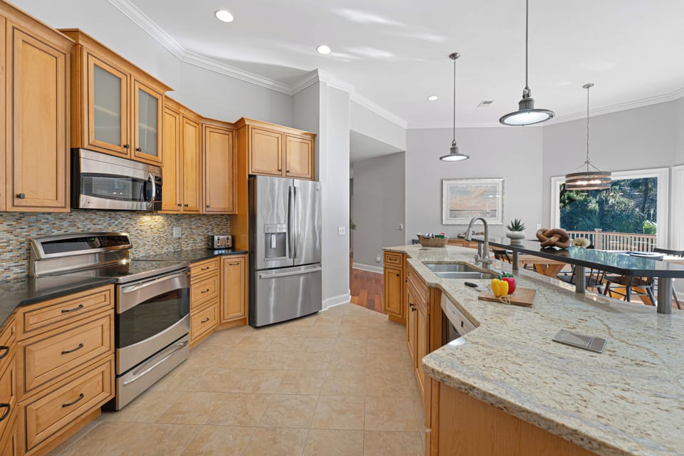 The chef's kitchen boasts high-end appliances perfect for cooking family meals or entertaining.