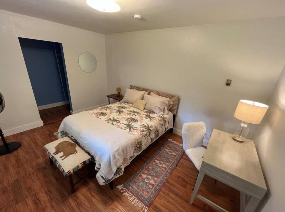 Bedroom 2 features a Queen size bed, dedicated work area with a desk and chair