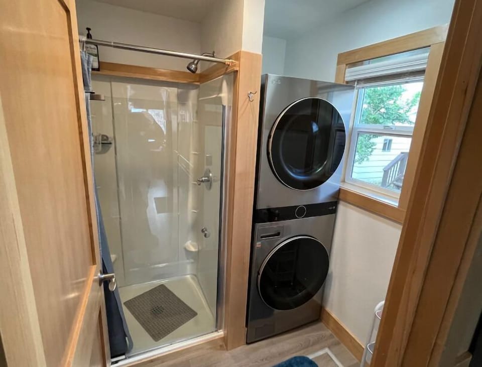 The bathroom shower and laundry area provide convenience during your stay
