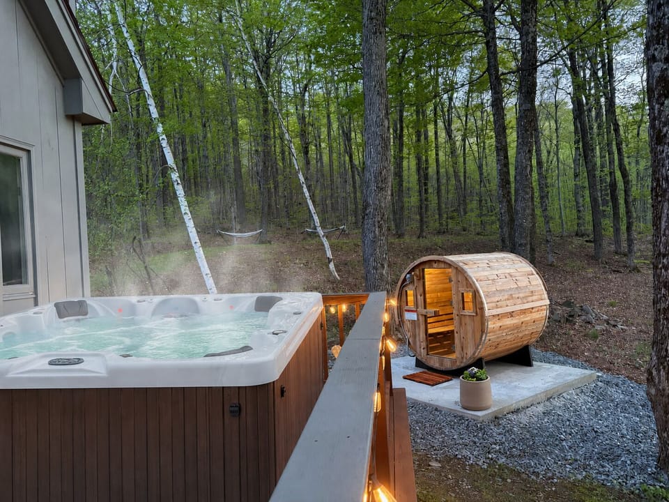 8 person hot tub • 6 person barrel sauna • Wooded sunset views • 2 Hammocks