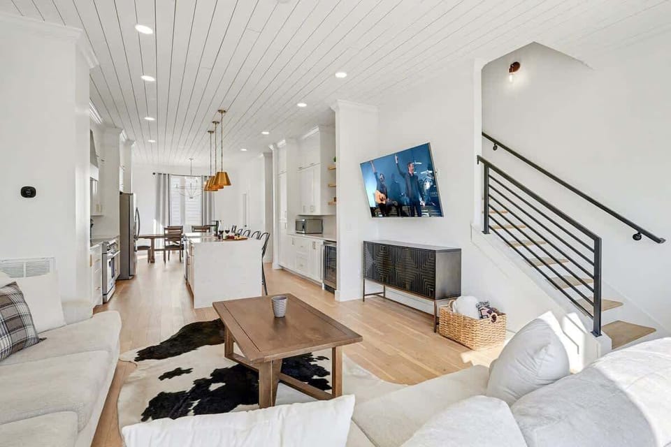 2nd Floor: Bright and open living area with cozy furnishings, a smart TV, and a private balcony.