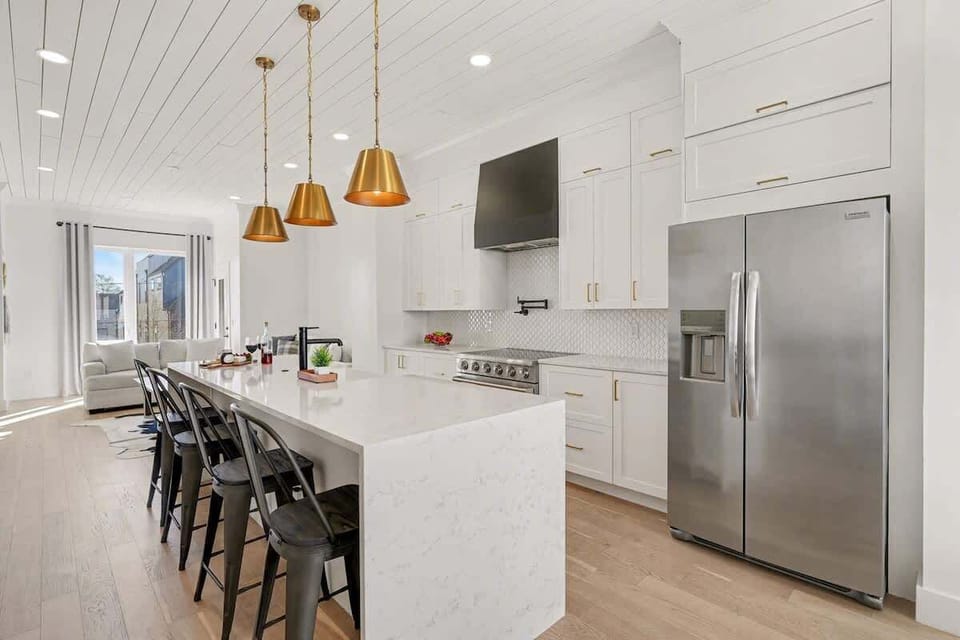 2nd Floor: Fully equipped kitchen with stainless steel appliances, a kitchen island with seating for 4 guests, wine cooler, and amble counter space.