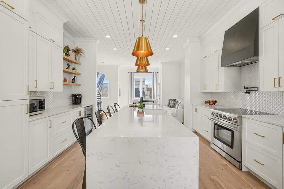 2nd Floor: Fully equipped kitchen with stainless steel appliances, a kitchen island with seating for 4 guests, wine cooler, and amble counter space.