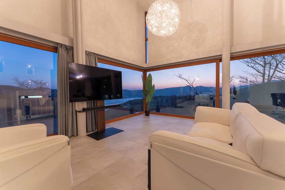 Panoramic Villa, Balcony, Lake View | Living area | 65-inch Smart TV with digital channels, DVD player