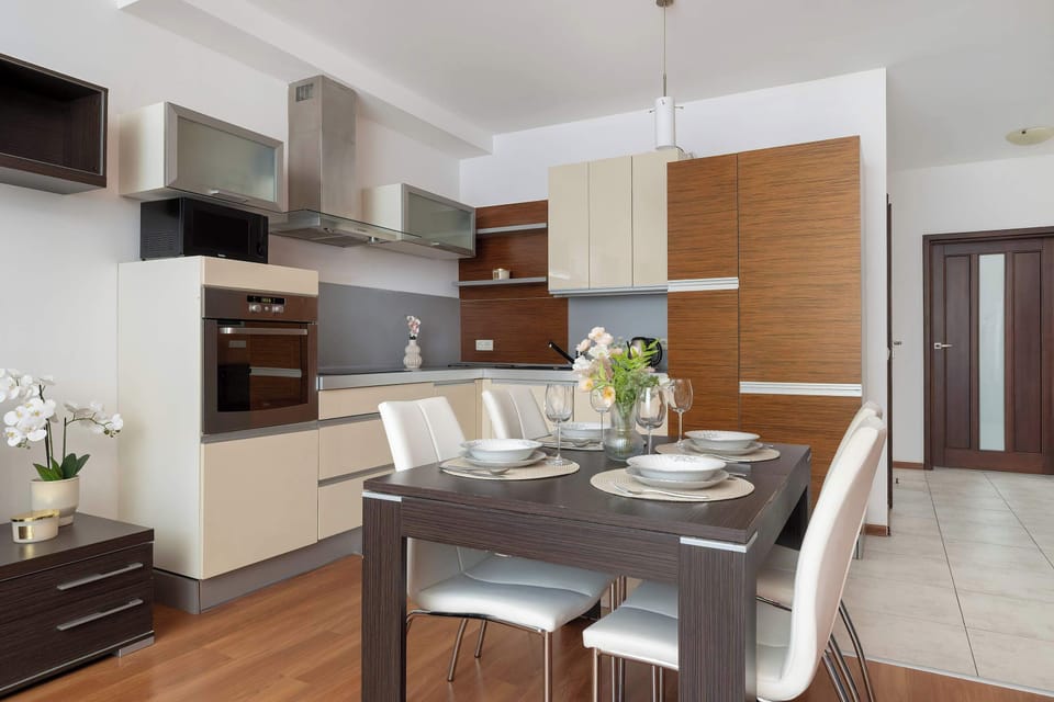 Elegant kitchenette with a modern dining table and tasteful lighting.