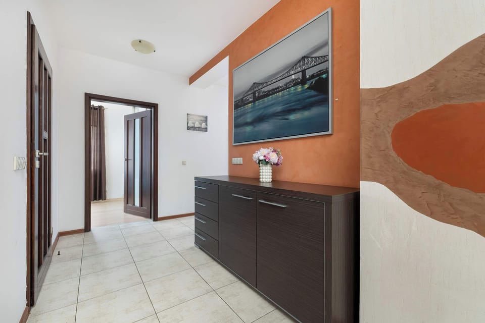 Tasteful hallway with artistic wall decor and refined interior style.