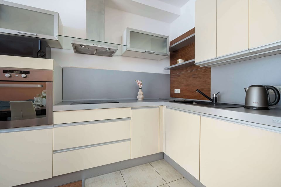 Sleek kitchenette with glossy cabinets and refined minimalist details.