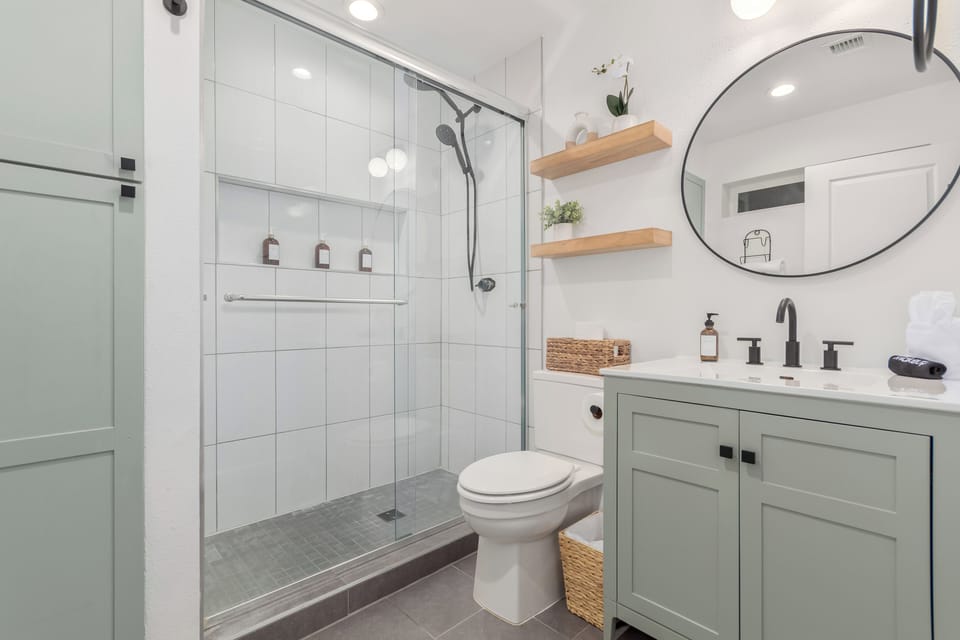 Primary en-suite bathroom with freshly updated glass/tile shower.
