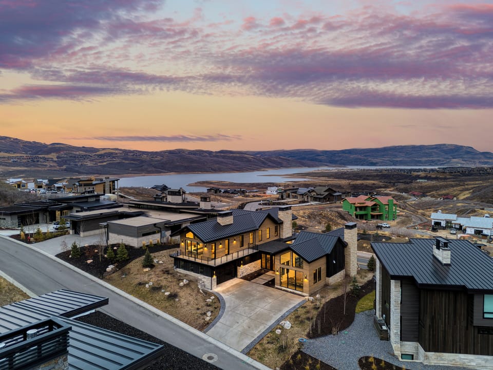 Sunset over the reservoir frames this contemporary retreat in a stunning mountain panorama.