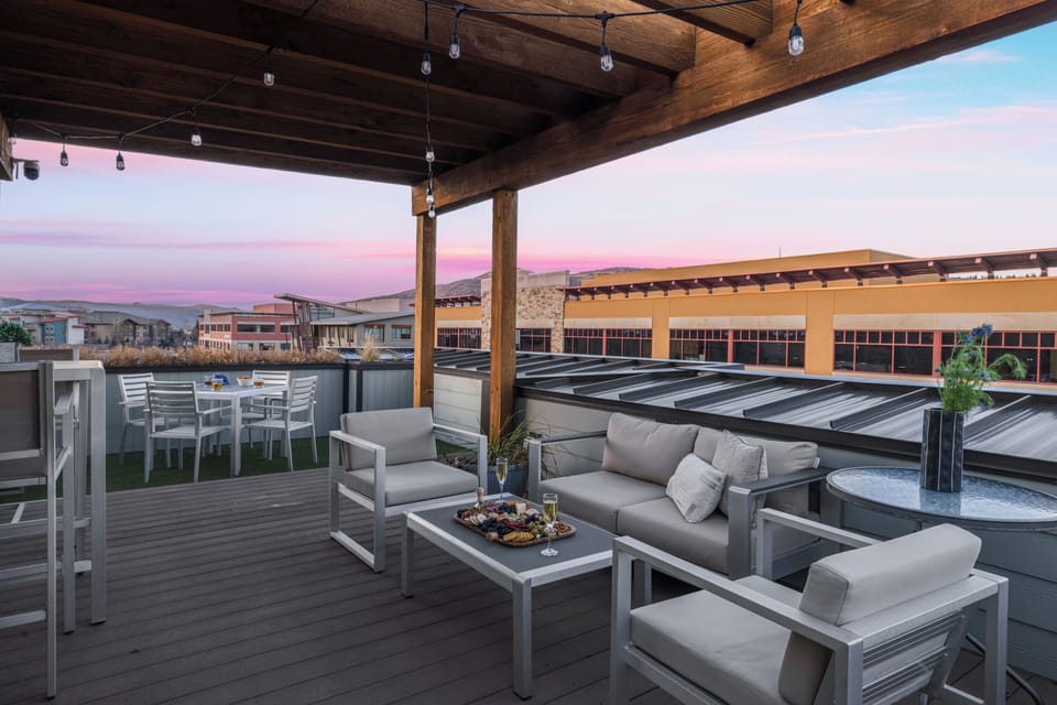 Rooftop terrace with multiple outdoor seating areas.