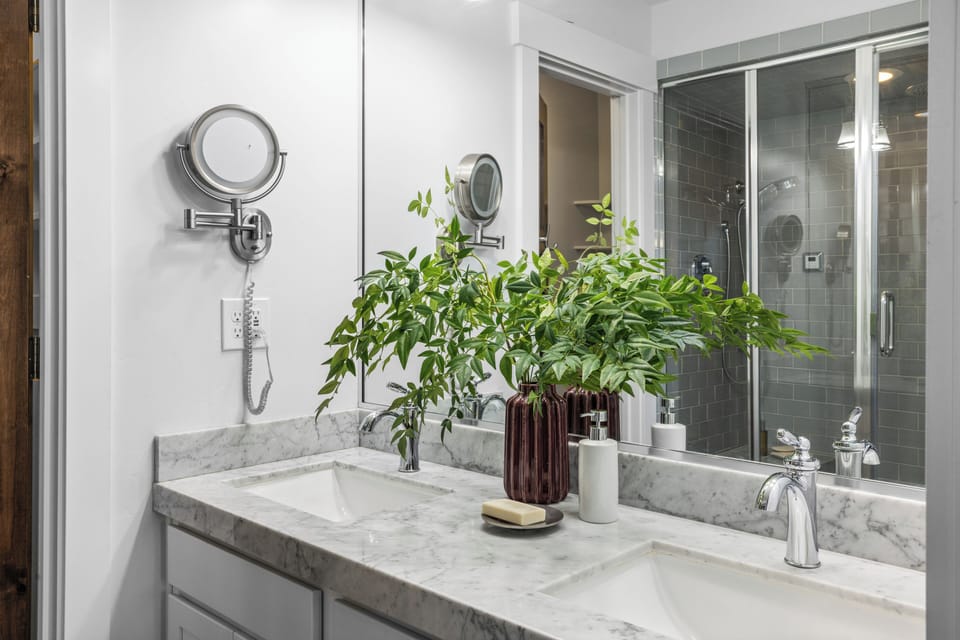 Ensuite bathroom 1 features a dual vanity and a shower with a bench.