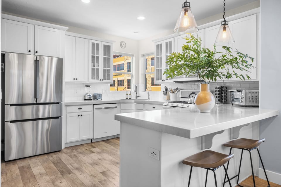 Kitchen featuring modern appliances and barstool seating.